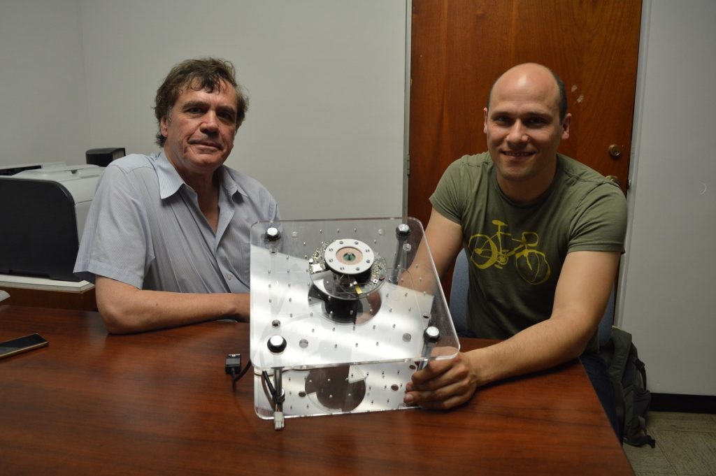 Prof. Marc Madou from University of California, Irvine and Dario Mager from KIT university showing a lab-on-a-CD.